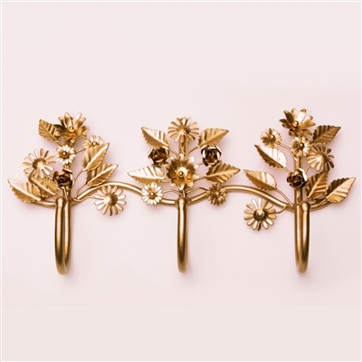 This floral wall hook comes with three hooks and features a soothing gold  finish. The hook has two key-hole hook on either ends for easy mounting.  This floral wall hook will look